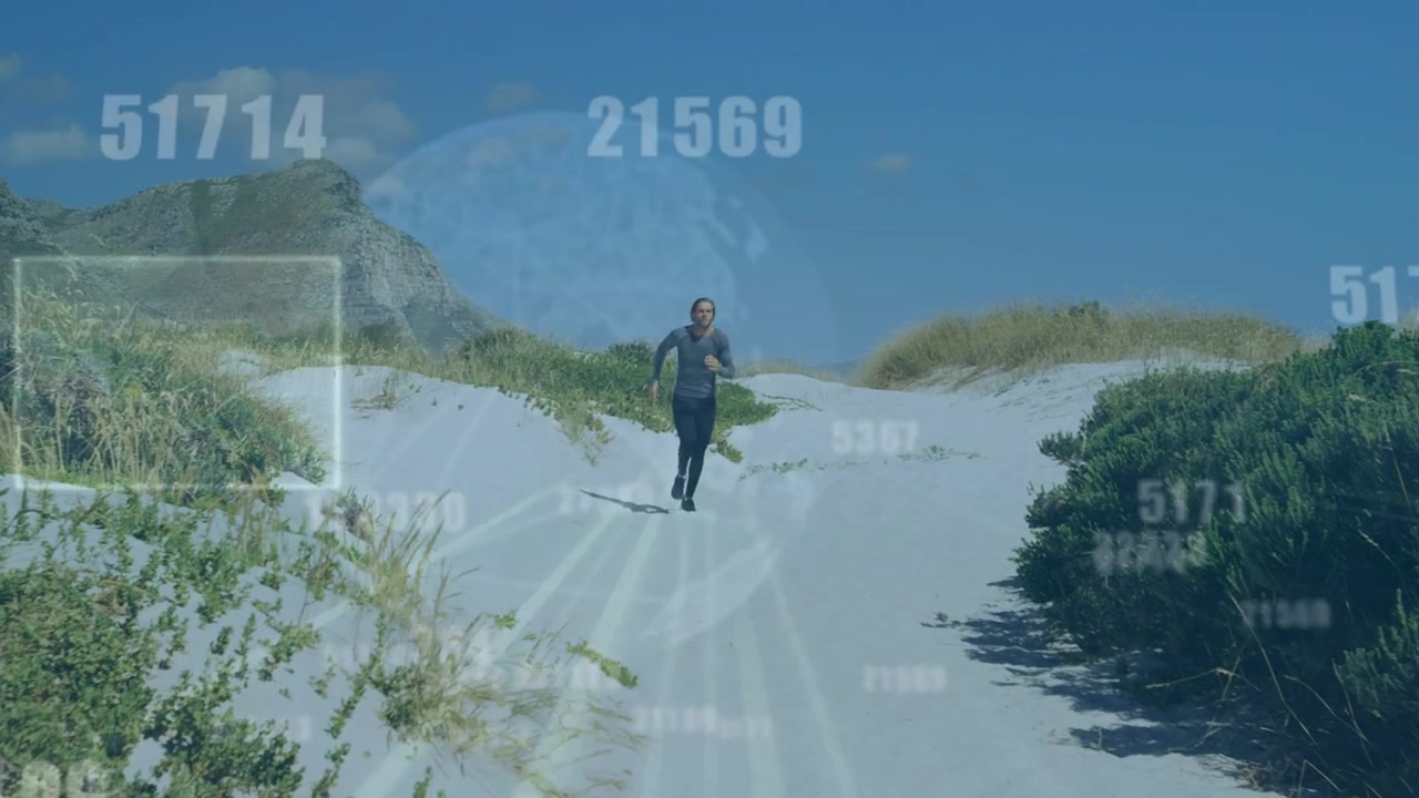 Male runner running down dune, approaching camera and activating floating numbers, globe for tech