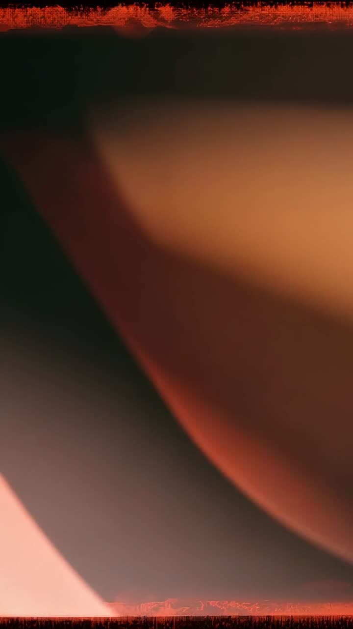 Vertical video: Shifting blurred gray curve across screen at start, showing soft orange hue shift