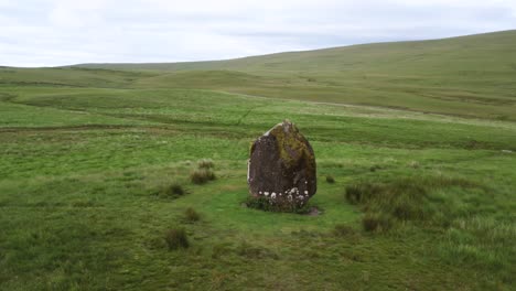 standing stone from bronze age in welsh countryside, maen llia, aerial orbital