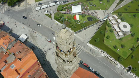 clérigos tower dynamic drone shot with a giant italian flag in the olive garden, porto, portugal