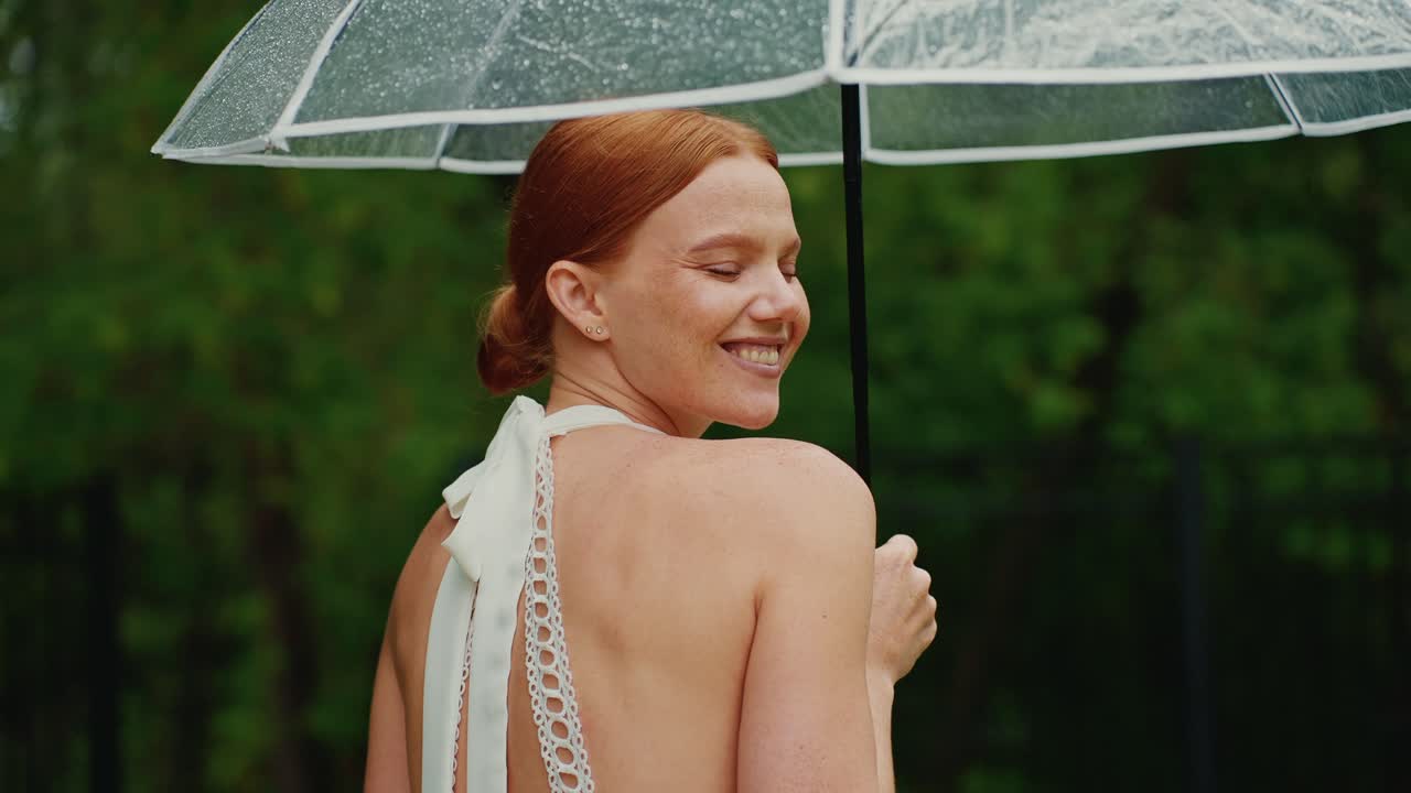 Woman under umbrella in the rain