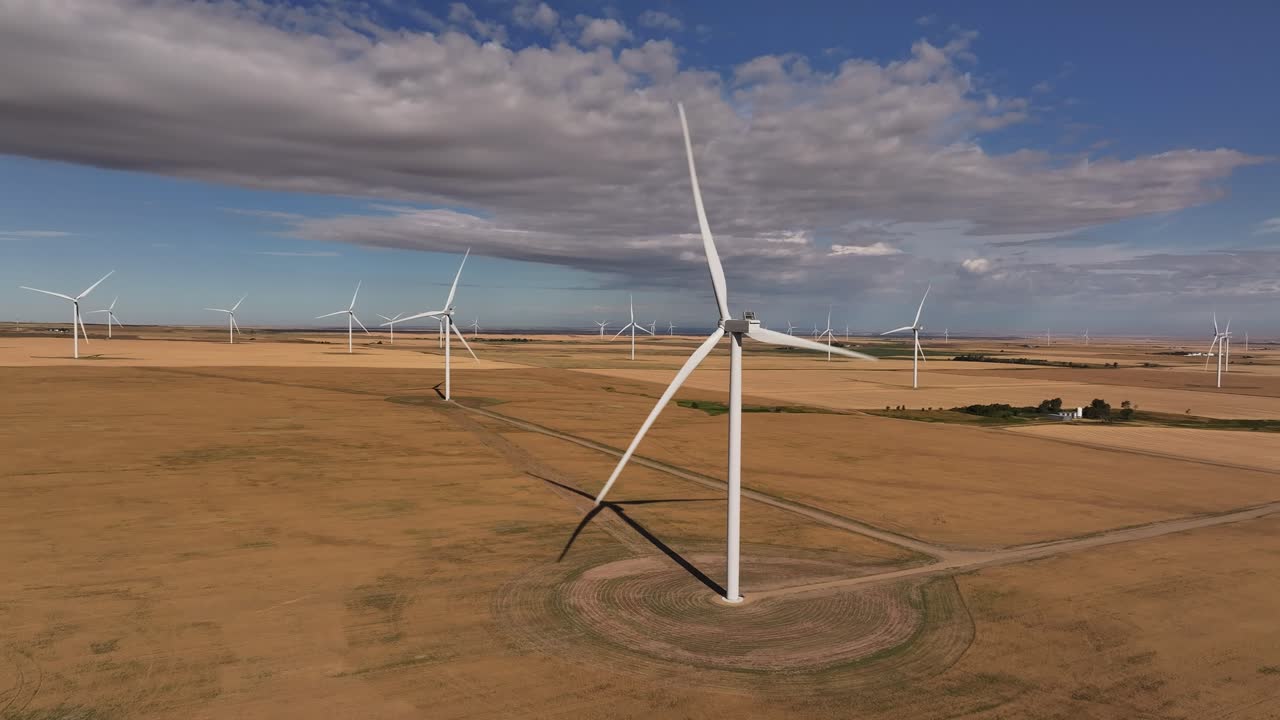 A drone flies up to a windmill on a wind farm in southern Alberta, Canada