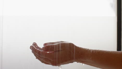 woman catching water, enjoying spa-like relaxation at home, feeling refreshed, copy space
