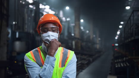 masked specialist touching face at modern digital energy production storage.