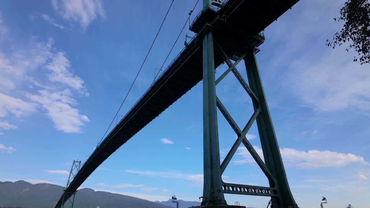 Gimbal close tilting-up shot of the Lions Gate Bridge pylon during sunny weather in Vancouver, British Columbia, Canada. 4K