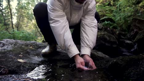 man hiking in a forest stream