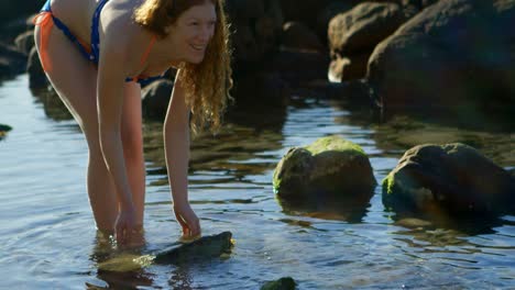 woman playing with water at the beach 4k