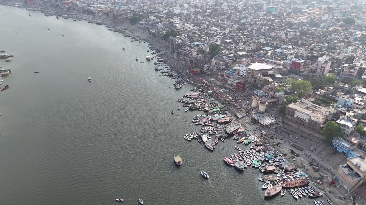 High-altitude shot capturing the vast, sprawling cityscape of Varanasi, with the Ganges serving as its spiritual and physical lifeline.