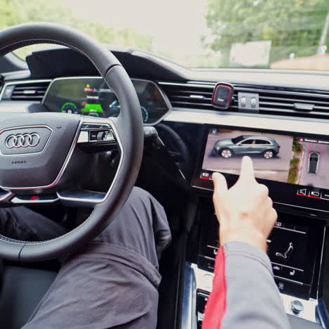 Inside view of a new electric car. Driver's hands on the steering wheel of audi e tron.
