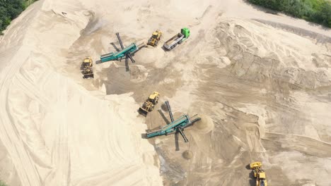 Aerial-view-loading-bulldozer-in-open-air-quarry