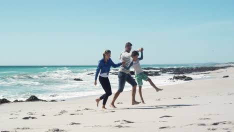 Couple-and-their-son-enjoying-free-time-on-the-beach-together