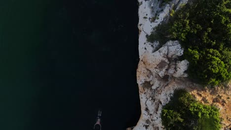 Man-swimming-on-Drachenaugensee-saltwater-lake