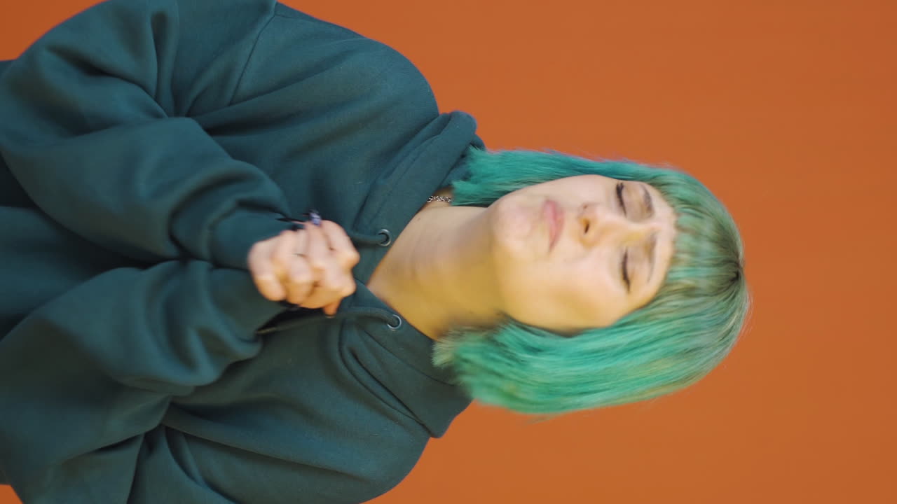 Vertical video of Young woman apologizing looking at camera.