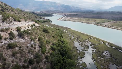 River-surrounded-by-fields-and-mountains,-Albania