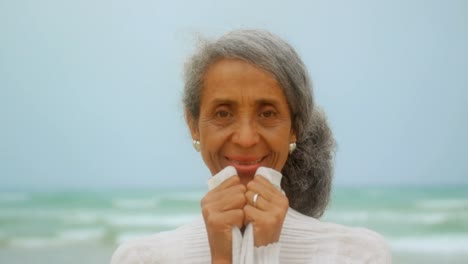 front view of happy active senior african american woman standing on the beach 4k