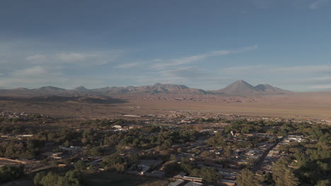 sideways flying drone shot above san pedro de atacama chile south america on a blue but cloudy day with mountains in the background log