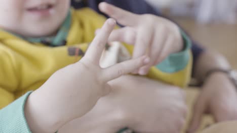 child playing with fingers