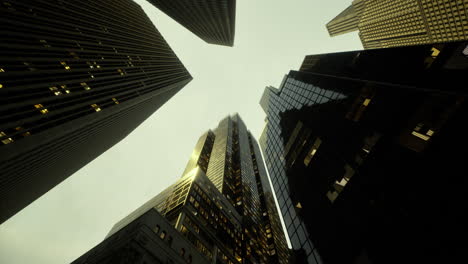 skyscrapers stretch upwards beneath a moody sky in an urban landscape