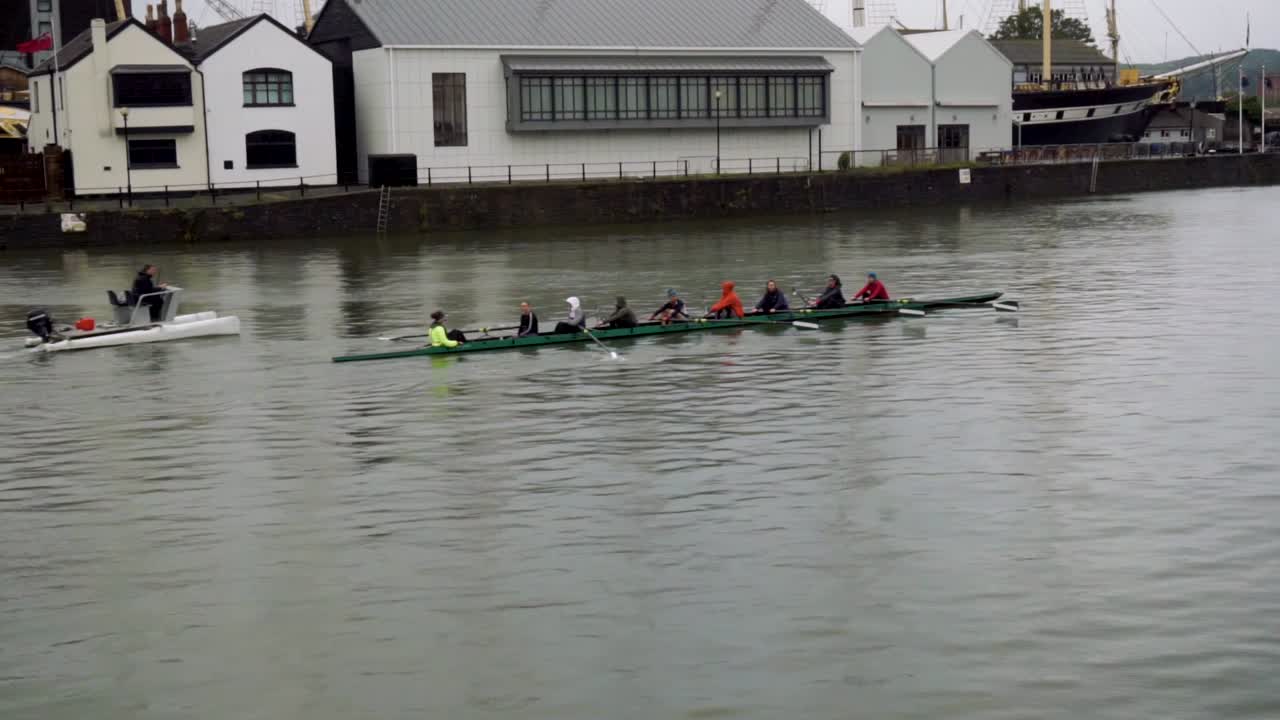 Handheld shot of rowers on the river Avon