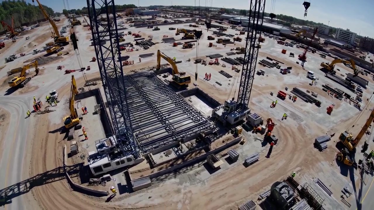 Aerial View of a Large Construction Site with Cranes and Heavy Machinery