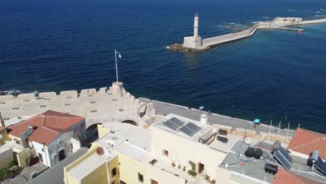 aerial view of iconic lighthouse in old venetian harbor of chania, crete, mediterranean sea