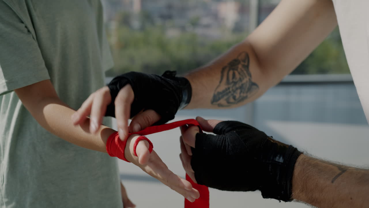 Child learning boxing with a trainer