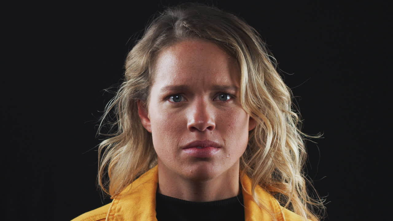 Head And Shoulders Studio Shot Of Angry Woman Shouting At Camera In Slow Motion