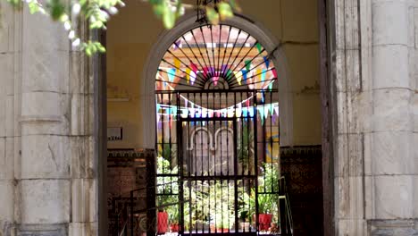 Man-Walking-in-Front-of-Gate-of-Andalusian-Patio