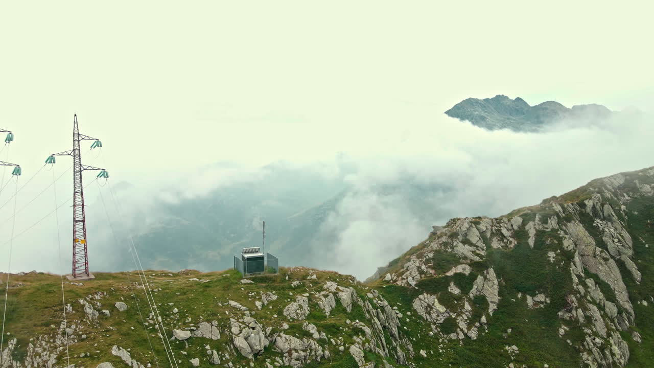 Foggy Mountaintop with Power Lines and Meteorological Station