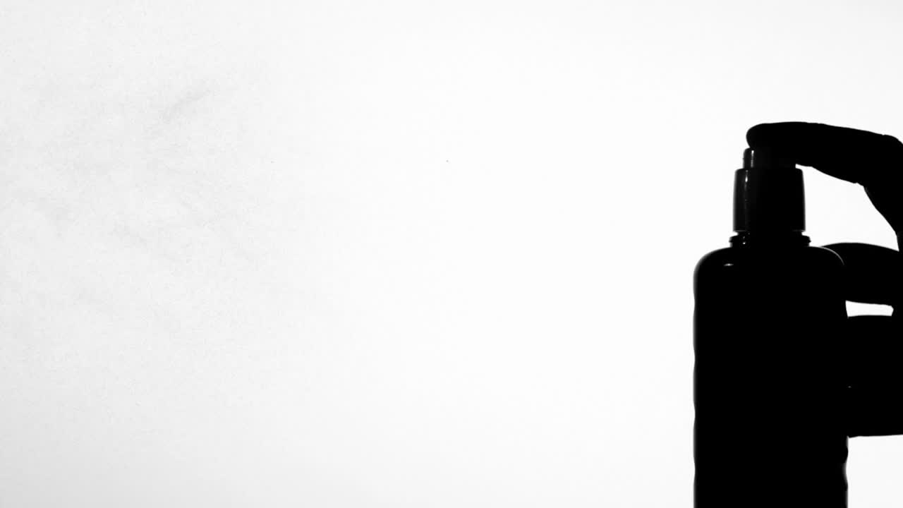 손으로 스프레이하는 선크림의 실루