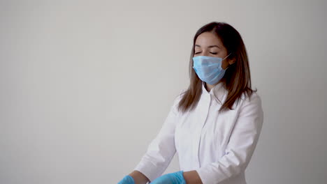 female nurse filling a syringe with a vaccine vial for covid 19