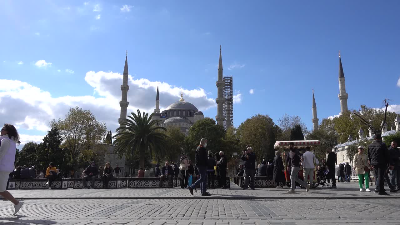 mezquita azul de estambul en la plaza sultanahmet, la gente está caminando descansando en un banco. pavo
