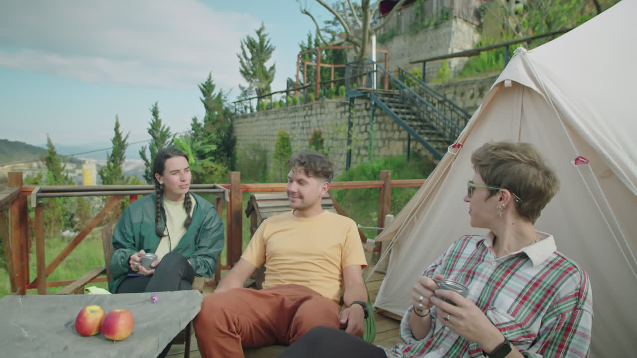 Company of Friends Enjoying Vacation at Glamp in Mountains