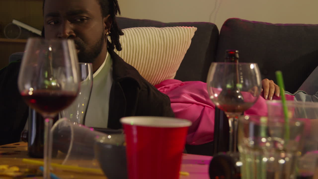 Close Up Of Couple Waking Up On Sofa After Drinking Alcohol At House Party Suffering With Hangover 1