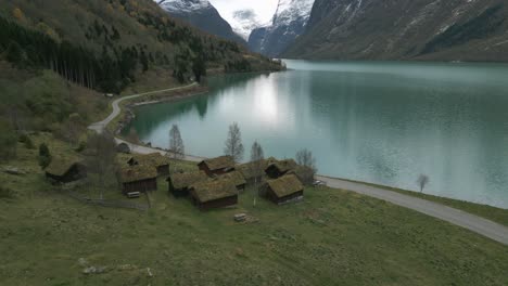 traditional norwegian houses by the serene lovatnet lake, cloudy day, aerial view