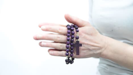 woman praying and holding cross in her hands on white background stock video