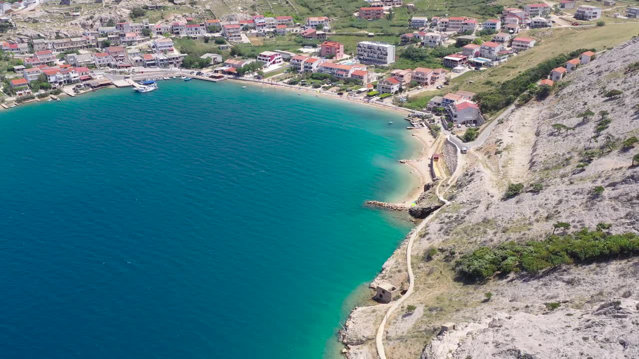 The waterfront of Metajna on the island of Otok Pag in Croatia with hotel beach resorts, Aerial flyover view