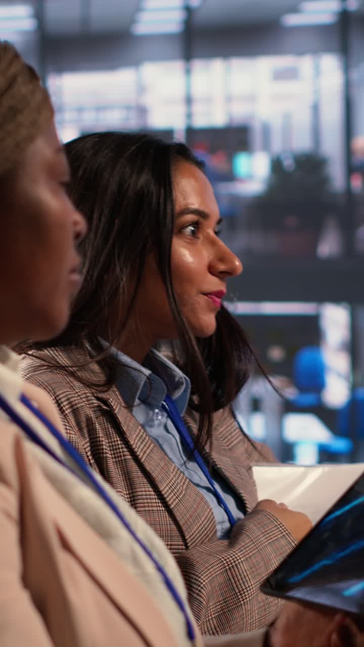Two Diverse Businesswomen Discussing Data on a Tablet