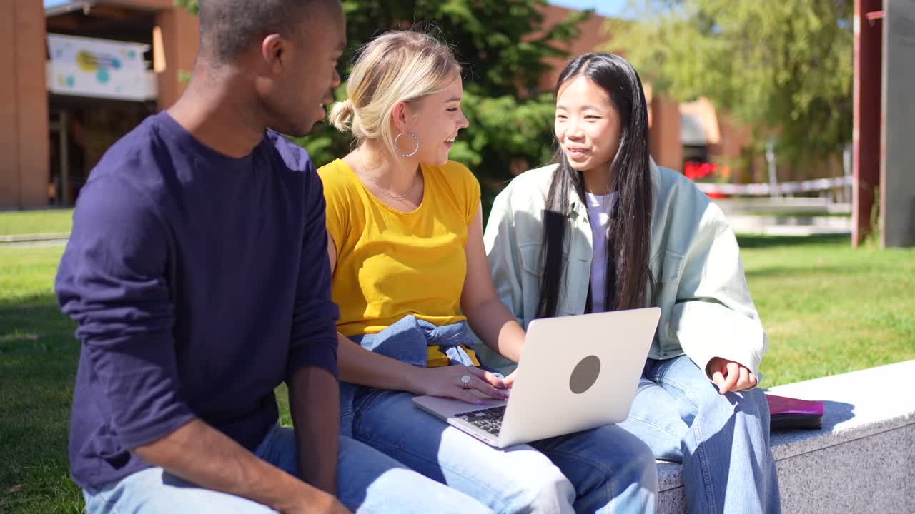 Students working on a laptop at university campus