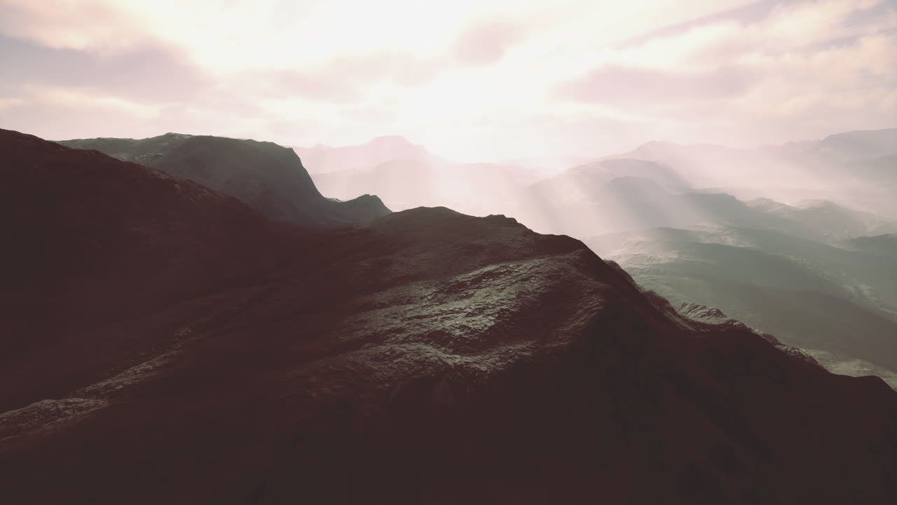 Misty mountain peaks bathed in golden sunlight during early morning hours