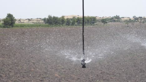 close up view of sprinkler pivot at work, watering crop for more growth