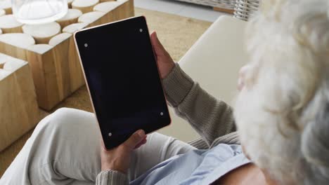 african american senior woman having a video call on digital tablet with copy space at home