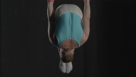 un hombre hace un entrenamiento de gimnasia en anillos