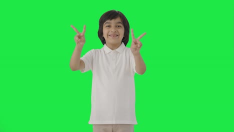 Happy-Indian-boy-showing-victory-sign-Green-screen