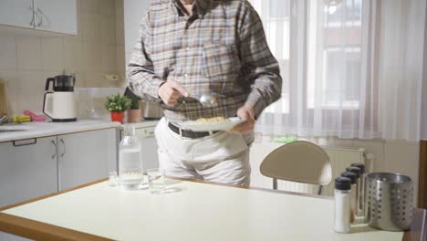 thoughtful old man is bored in the kitchen.