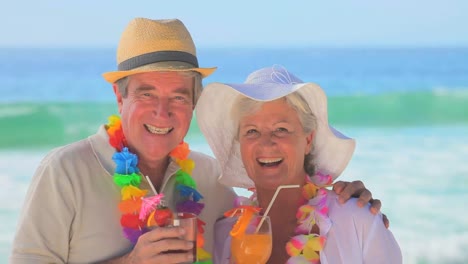 elderly couple wearing garlands and hats