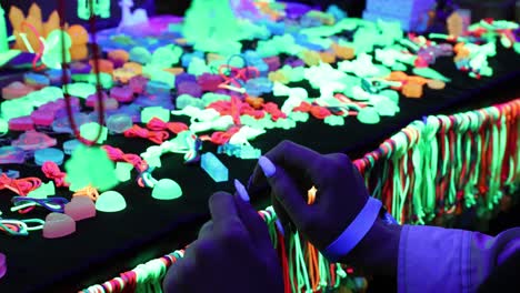 a person arranging colorful feathers for a craft project