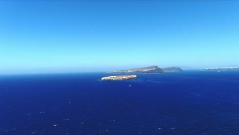 Aerial-4K-Blue-Sea-and-Sky-Top-View-Towards-Distant-Tropical-Islands-in-horizontal-motion-in-Santorini-Greece