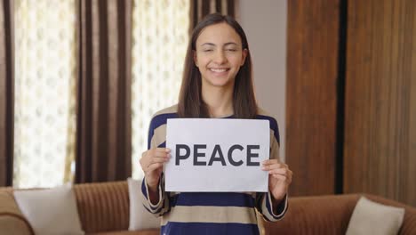 happy indian woman holding peace banner