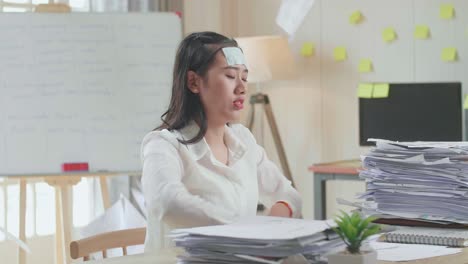 sick asian woman throw away the paper while working hard with documents at the office